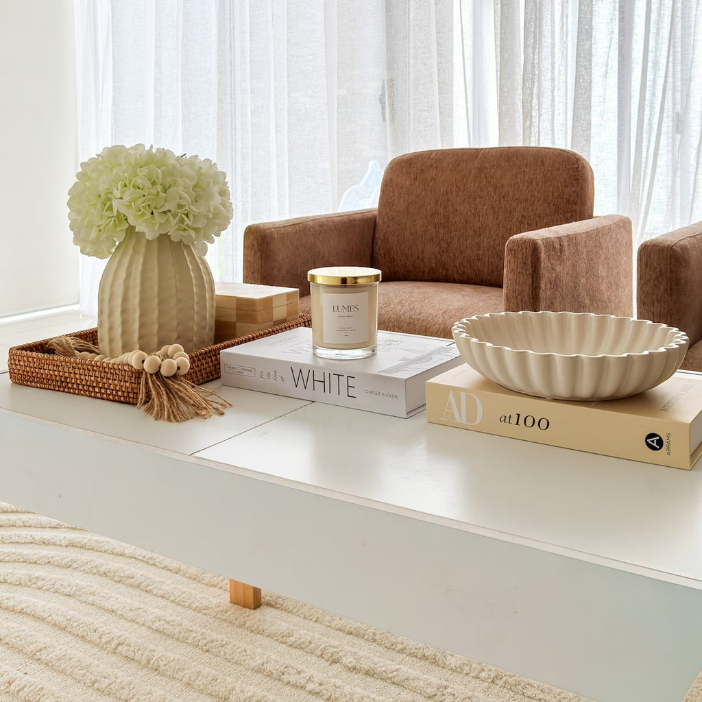 Living room with a brown armchair, coffee table, and decorative items.
